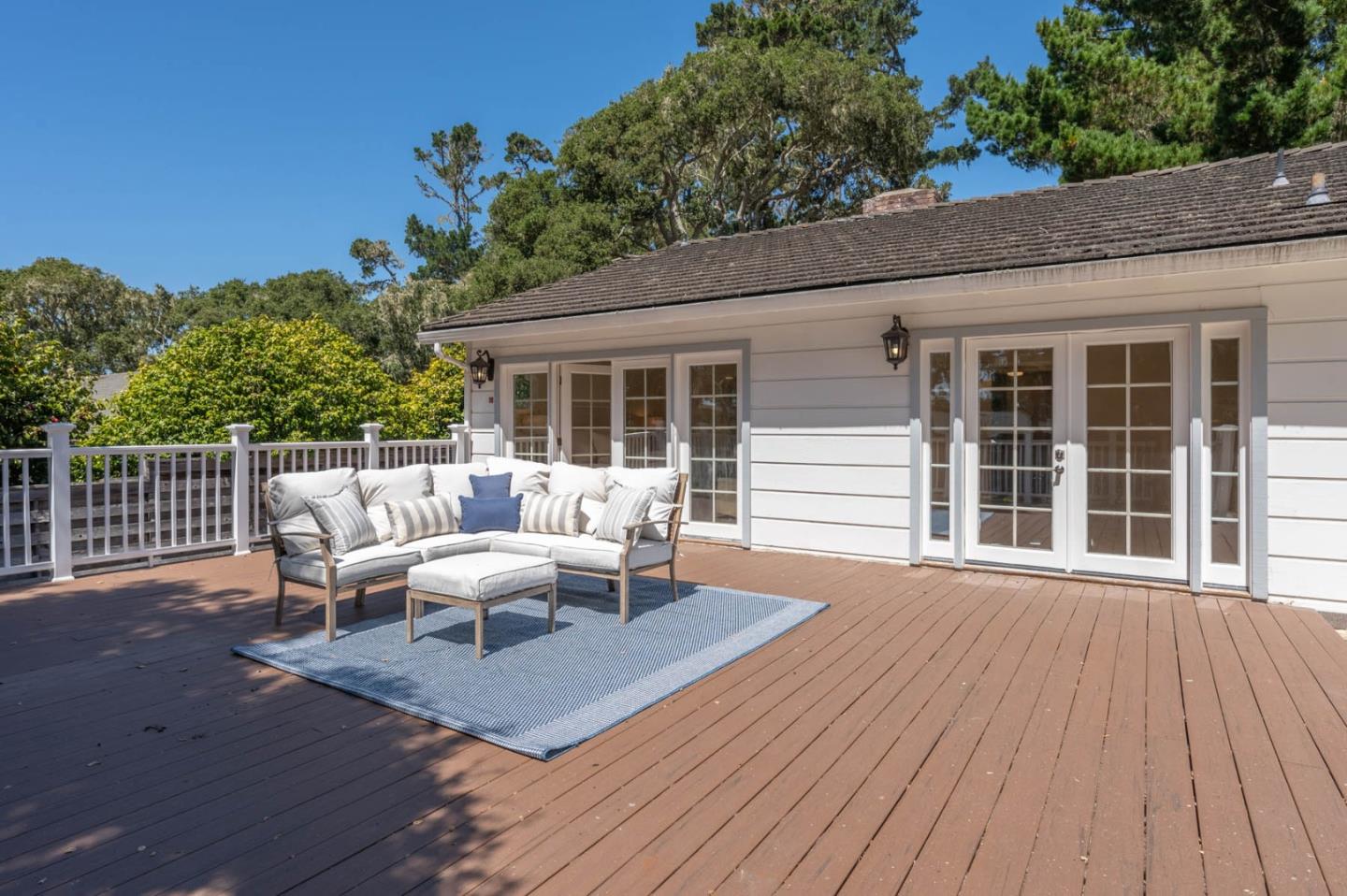 1044 Lost Barranca Road Pebble Beach, CA 93953 - Photo 10 of 15 a view of a deck with table and chairs and wooden floor