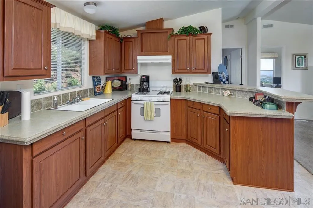 5495 Acorn Patch Road Julian, CA 92036 - Photo 13 of 23 a kitchen with a sink stove and cabinets