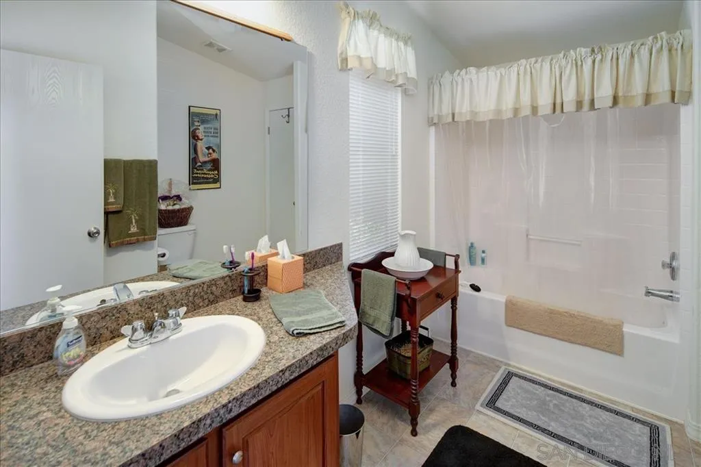 5495 Acorn Patch Road Julian, CA 92036 - Photo 14 of 23 a bathroom with a granite countertop sink and a mirror