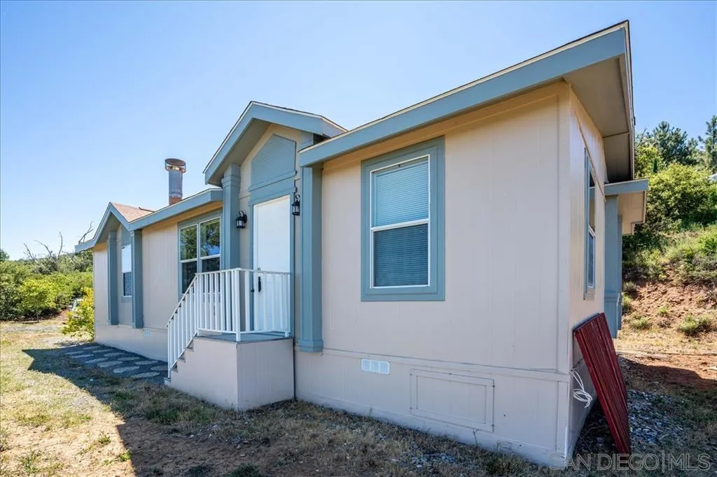 5495 Acorn Patch Road Julian, CA 92036 - Photo 3 of 23 a front view of a house with garden