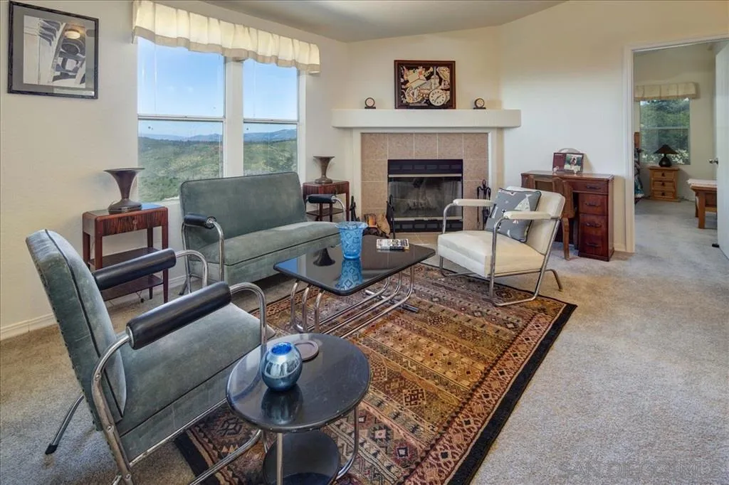 5495 Acorn Patch Road Julian, CA 92036 - Photo 10 of 23 a living room with furniture a rug and a fireplace