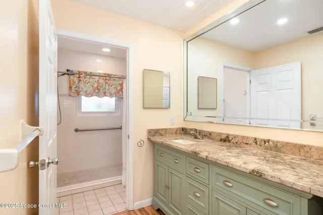 a bathroom with a granite countertop sink mirror and double