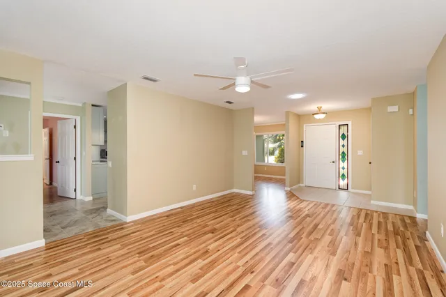 a view of an empty room and wooden floor