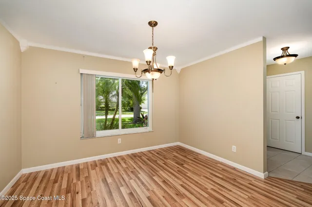 a view of a room with wooden floor fan and a window