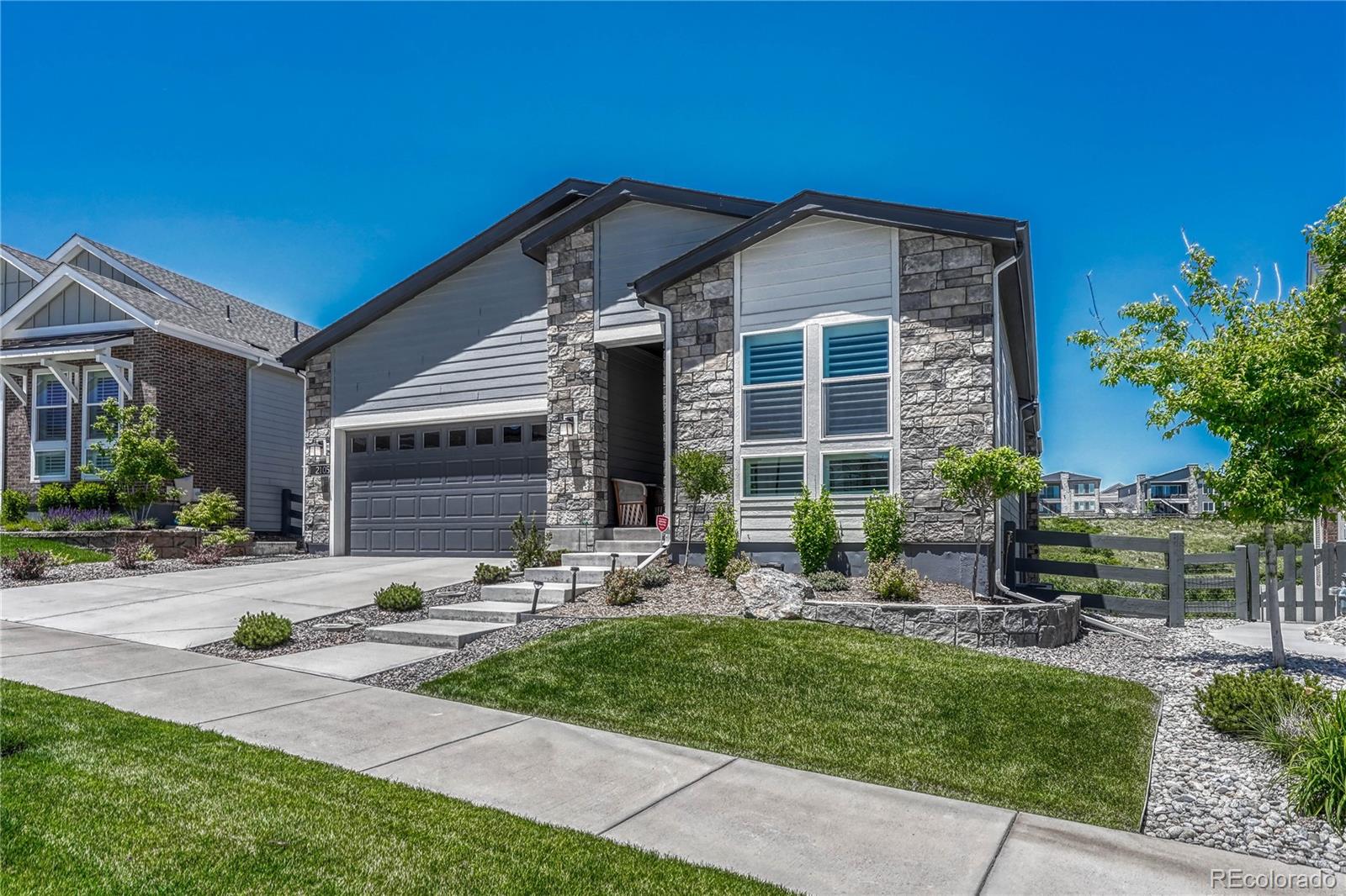 2105 Rim Ridge Drive Castle Pines, CO 80108 - Photo 1 of 38 a front view of a house with a yard