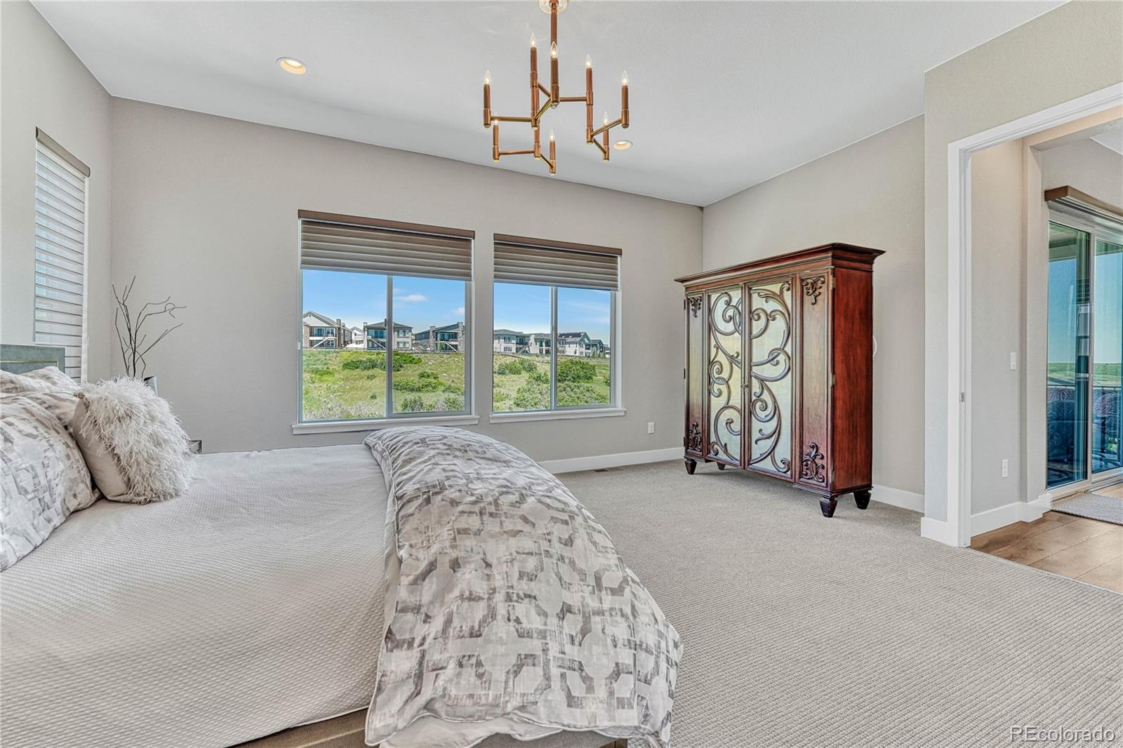 2105 Rim Ridge Drive Castle Pines, CO 80108 - Photo 18 of 38 a bedroom with a bed and a window