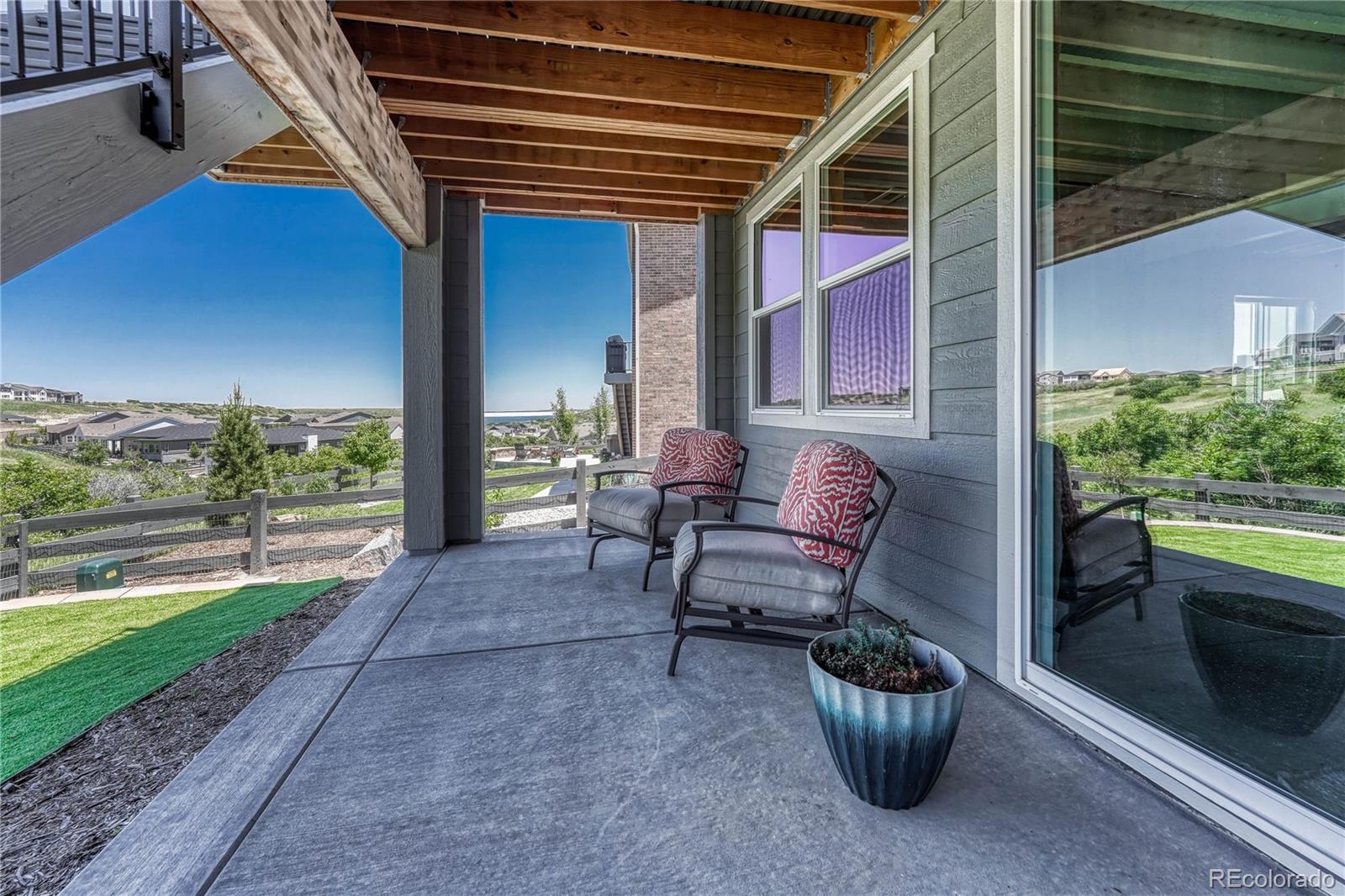 2105 Rim Ridge Drive Castle Pines, CO 80108 - Photo 33 of 38 a view of a patio with couches chairs and potted plants