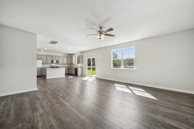 a view of a kitchen with wooden floor and a kitchen