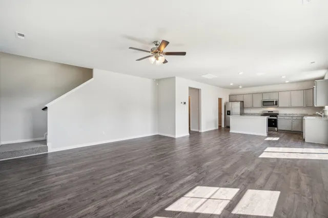 a view of a kitchen with wooden floor and a kitchen space