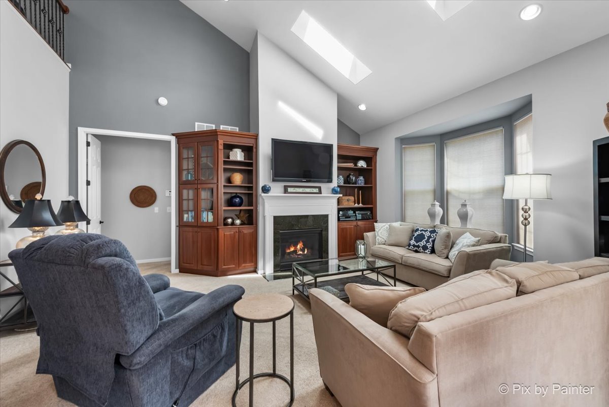 3879 Seigle Drive Elgin, IL 60124 - Photo 11 of 44 a living room with furniture a fireplace and a flat screen tv