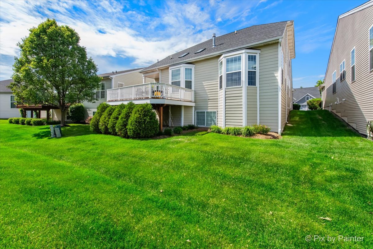 3879 Seigle Drive Elgin, IL 60124 - Photo 31 of 44 a front view of a house with a garden and yard