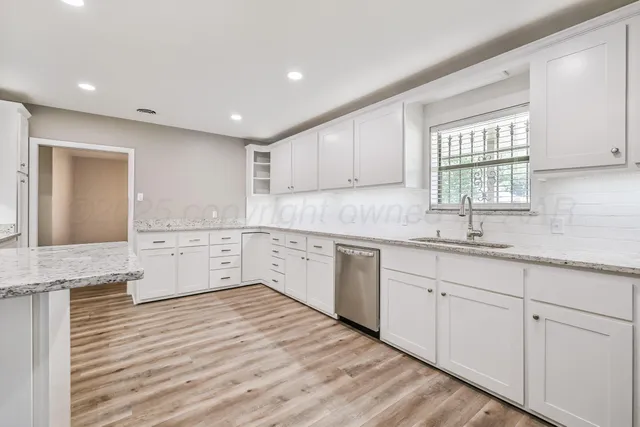 a kitchen with sink cabinets and window