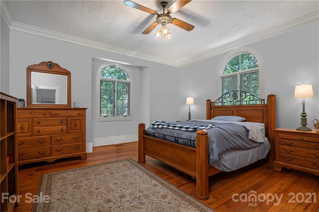15 Doubleday Road Tryon, NC 28782 - Photo 18 of 46 a bedroom with a bed and a dresser next to a window