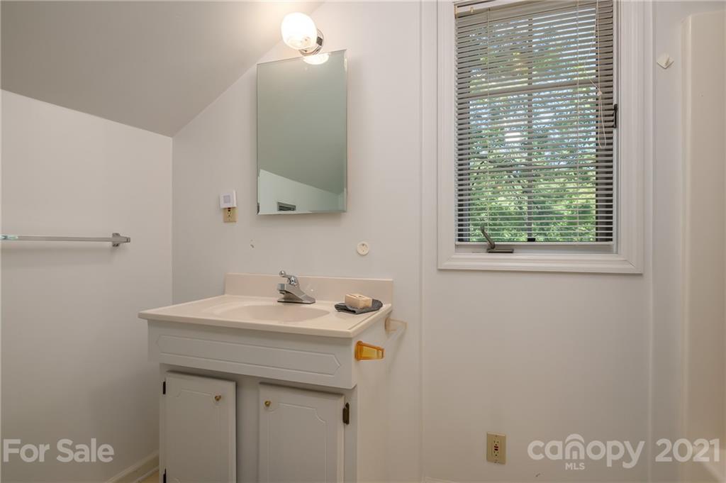 15 Doubleday Road Tryon, NC 28782 - Photo 27 of 46 a bathroom with a sink a vanity and a mirror