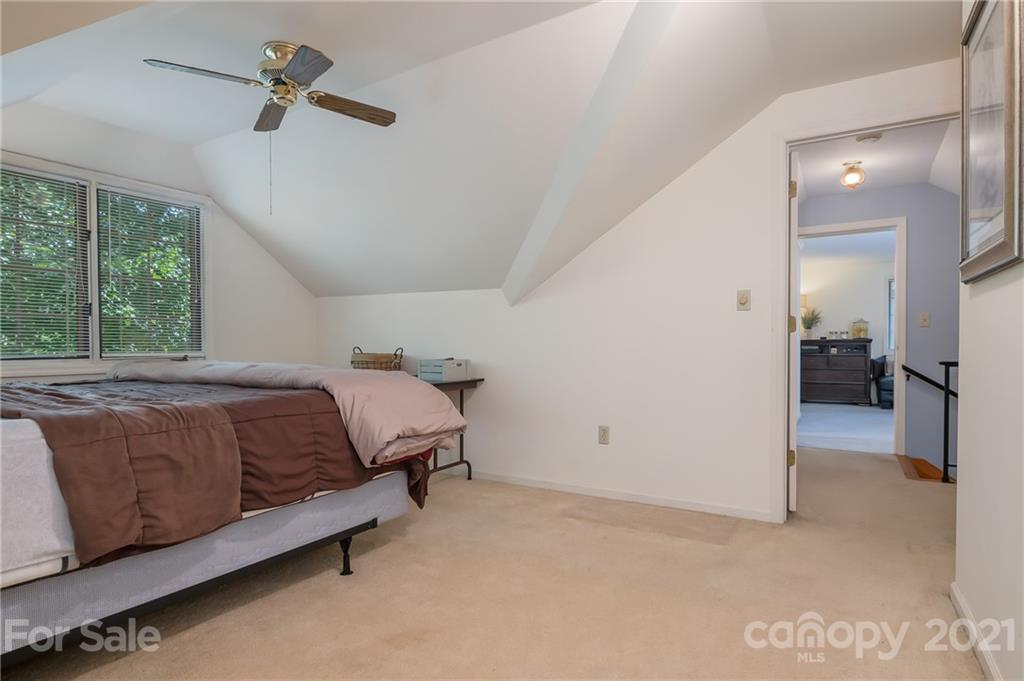 15 Doubleday Road Tryon, NC 28782 - Photo 28 of 46 a spacious bedroom with a bed and a dresser