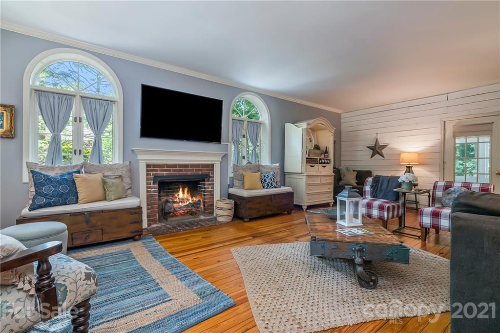 15 Doubleday Road Tryon, NC 28782 - Photo 9 of 46 a living room with furniture a flat screen tv and a fireplace