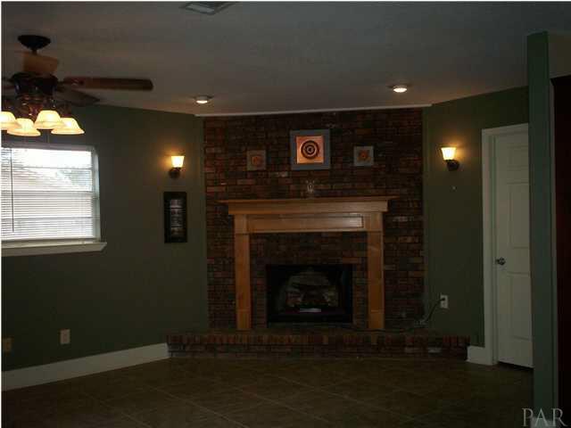6925 Frank Reeder Road Pensacola, FL 32526 - Photo 12 of 13 Tiled great room with fireplace....wood burning fireplace...seller has an electric insert for show