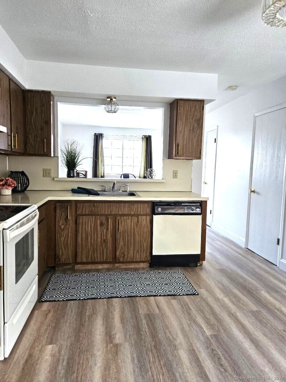 a kitchen with granite countertop a sink and cabinets