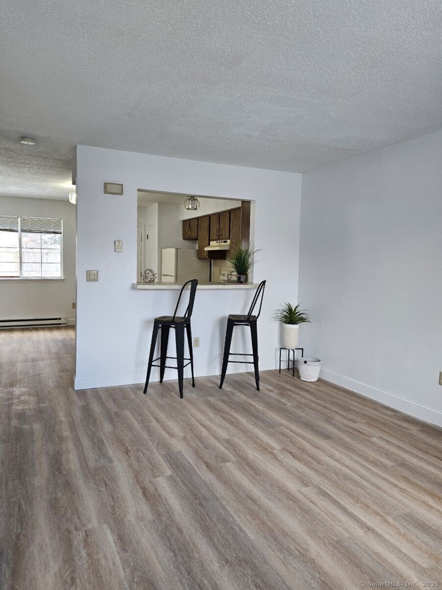 975 Meriden Road, Unit 11 Waterbury, CT 06705 - Photo 13 of 27 a living room with furniture and a wooden floor