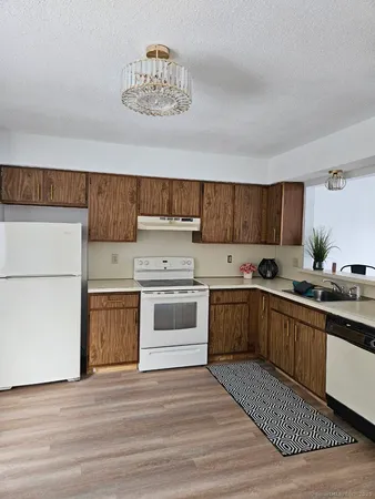 a kitchen with a white cabinets and white appliances