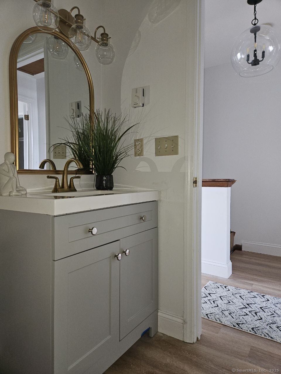 975 Meriden Road, Unit 11 Waterbury, CT 06705 - Photo 19 of 27 a bathroom with a sink a mirror and vanity