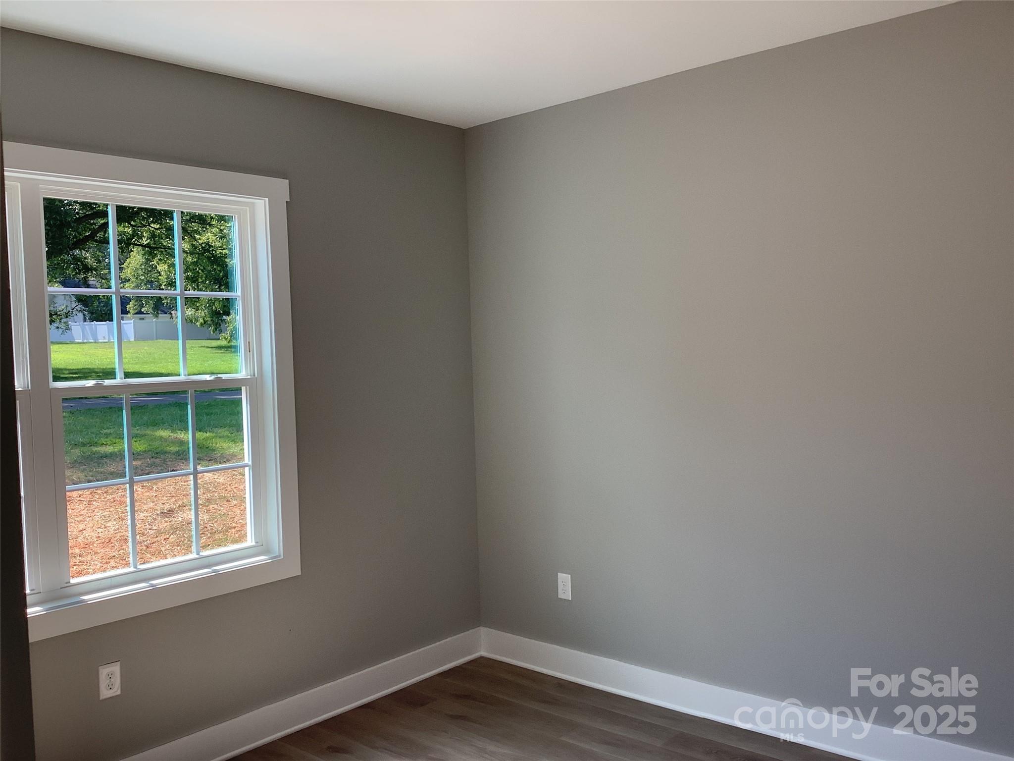 302 West 2nd Street Lowell, NC 28098 - Photo 16 of 17 a view of a small space with wooden floor and a window