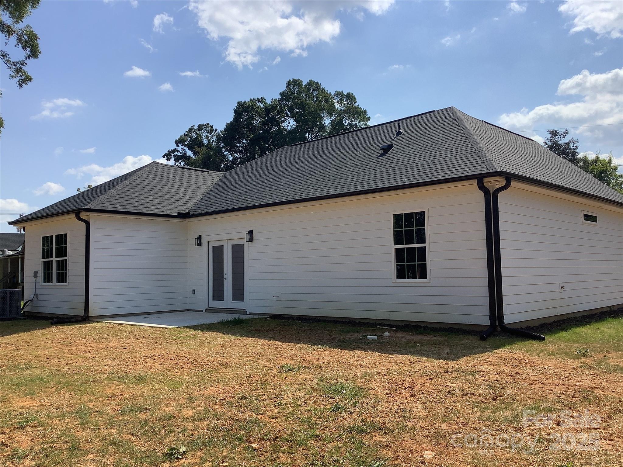 302 West 2nd Street Lowell, NC 28098 - Photo 2 of 17 a house with a yard