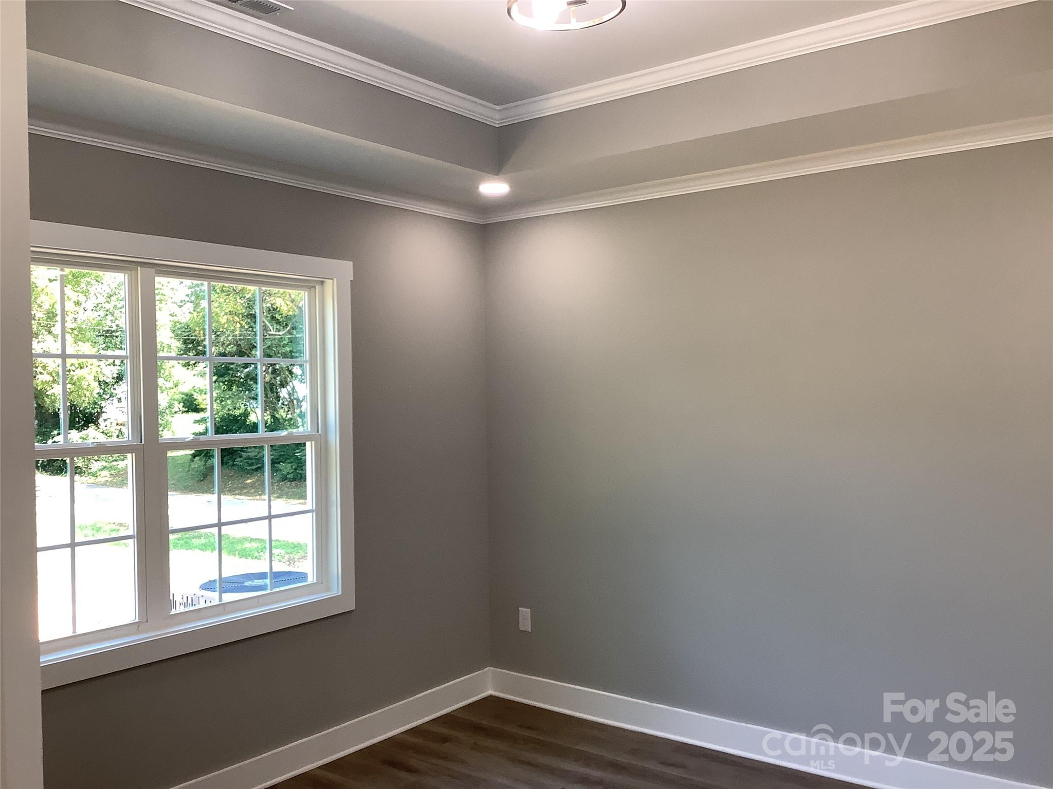 302 West 2nd Street Lowell, NC 28098 - Photo 8 of 17 a view of empty room with wooden floor and fan