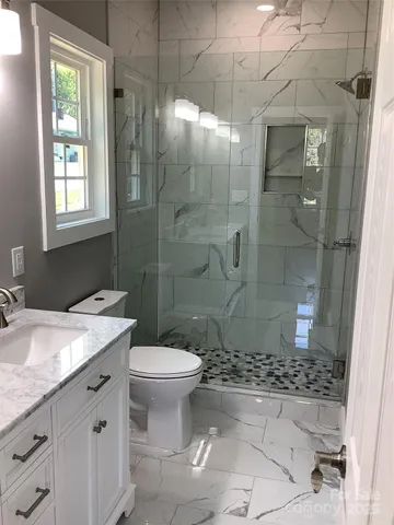 a bathroom with a sink toilet and shower