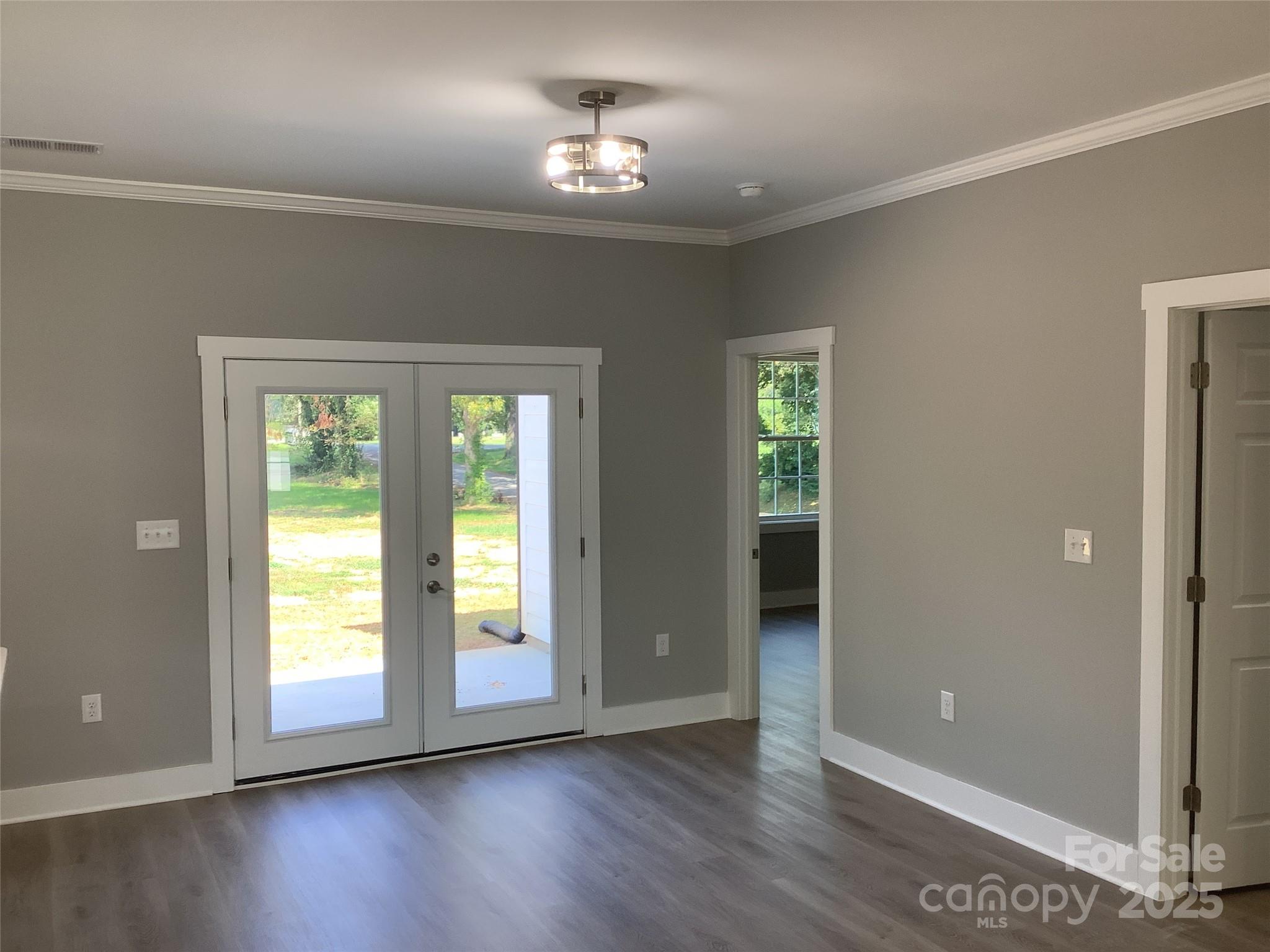 302 West 2nd Street Lowell, NC 28098 - Photo 10 of 17 a view of an empty room with wooden floor and a window