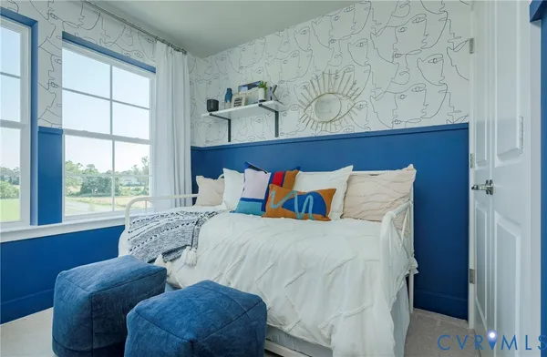 a bed sitting in a bedroom next to a window