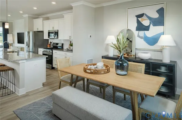 a view of kitchen with cabinets table and chairs