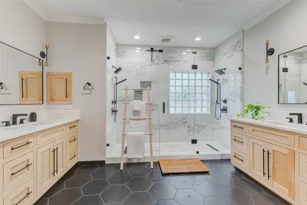 a spacious bathroom with a shower sink and mirror