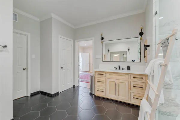a kitchen with white cabinets and appliances