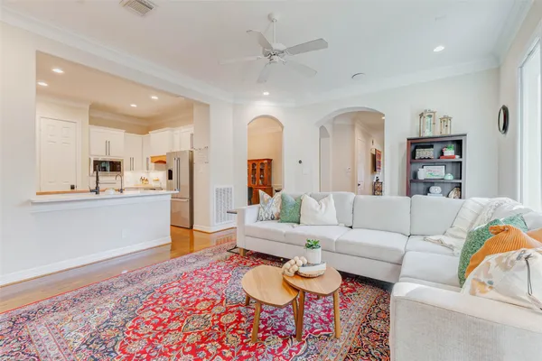 a living room with furniture and kitchen view