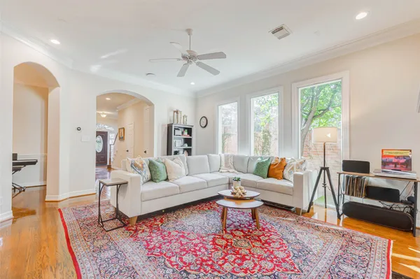 a dining room with furniture a chandelier and window