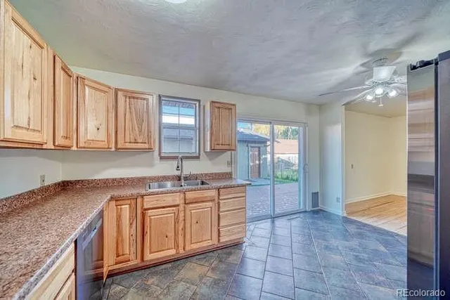 a kitchen with a sink cabinets and window