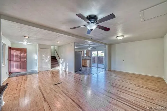 a view of an empty room and wooden floor