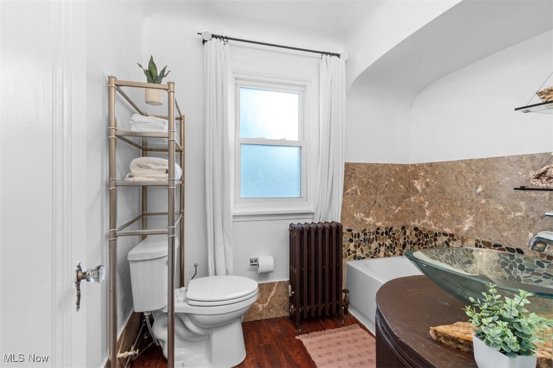 3609 Northcliffe Road University Heights, OH 44118 - Photo 14 of 26 Full bath with radiator, wood finished floors, and a bathtub