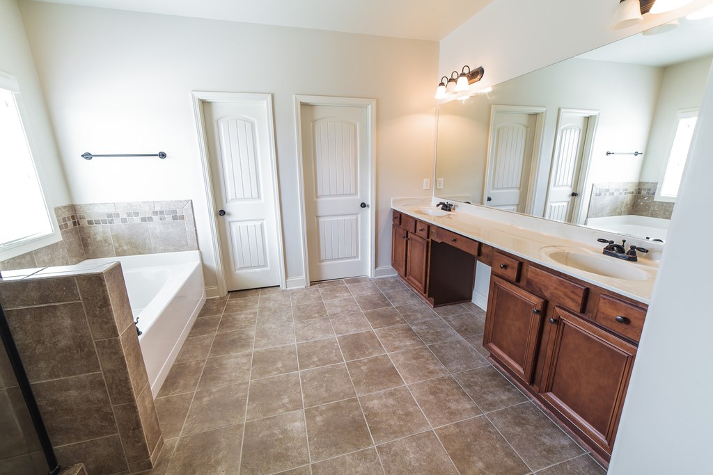 82 Riverside Landing Fort Mitchell, AL 36856 - Photo 27 of 47 a large bathroom with a sink a vanity and mirror