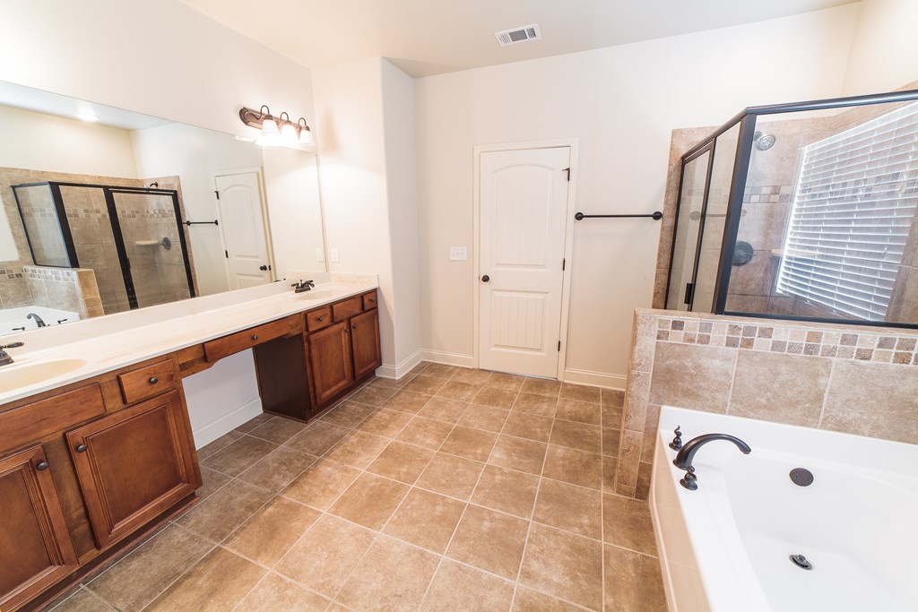82 Riverside Landing Fort Mitchell, AL 36856 - Photo 31 of 47 a bathroom with a tub sink and mirror