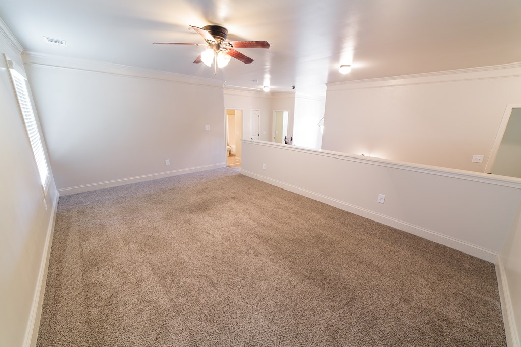 82 Riverside Landing Fort Mitchell, AL 36856 - Photo 39 of 47 an empty room with chandelier fan and windows