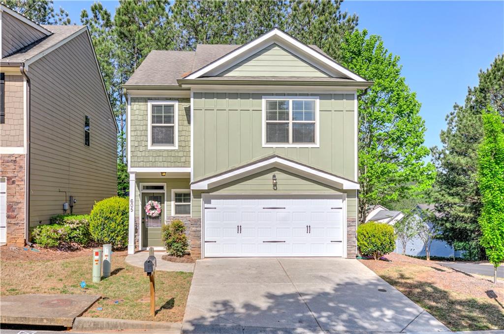 605 Summit Point Canton, GA 30114 - Photo 2 of 56 a front view of a house with a yard and garage
