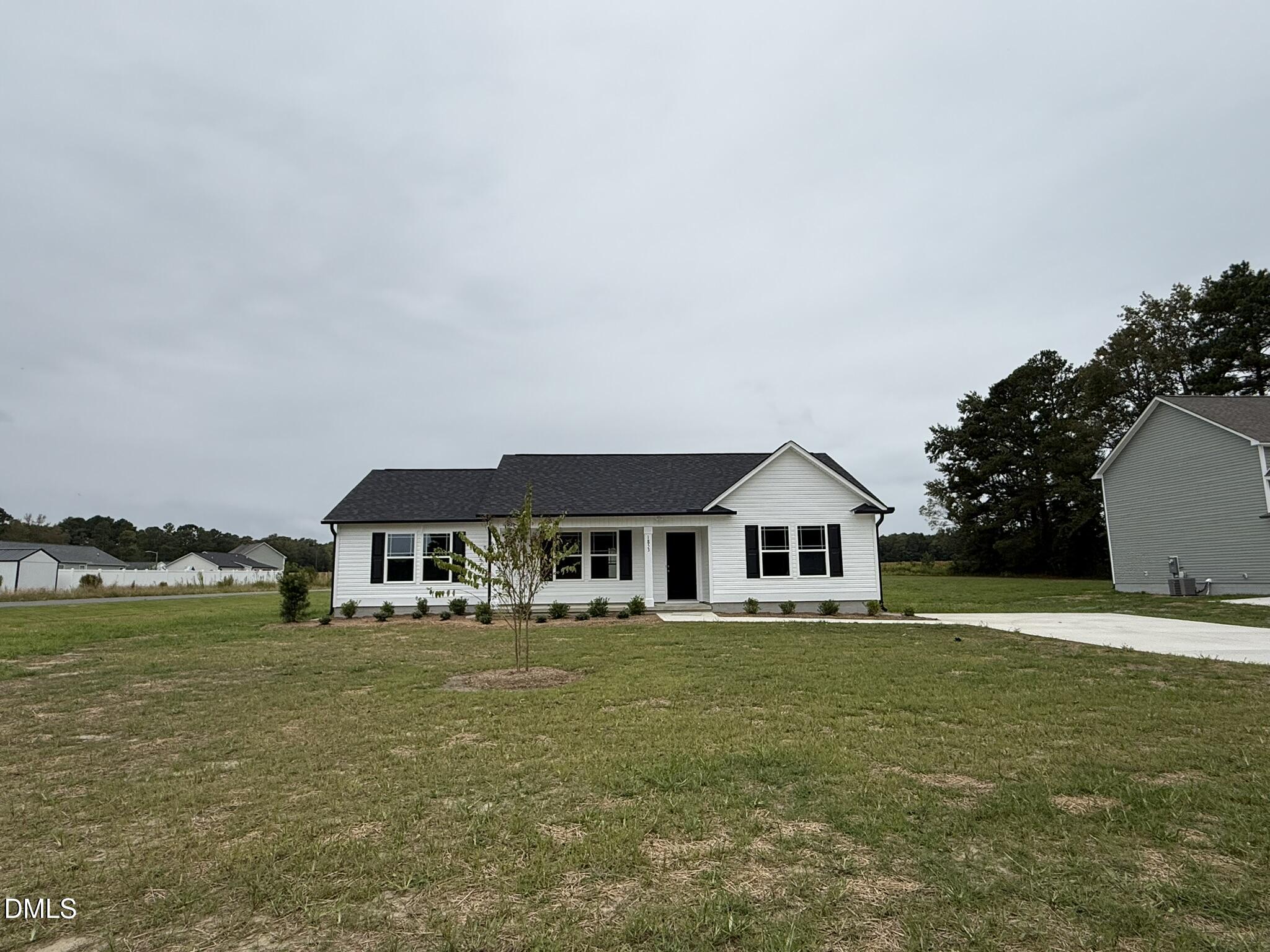 a front view of a house with garden and lake view
