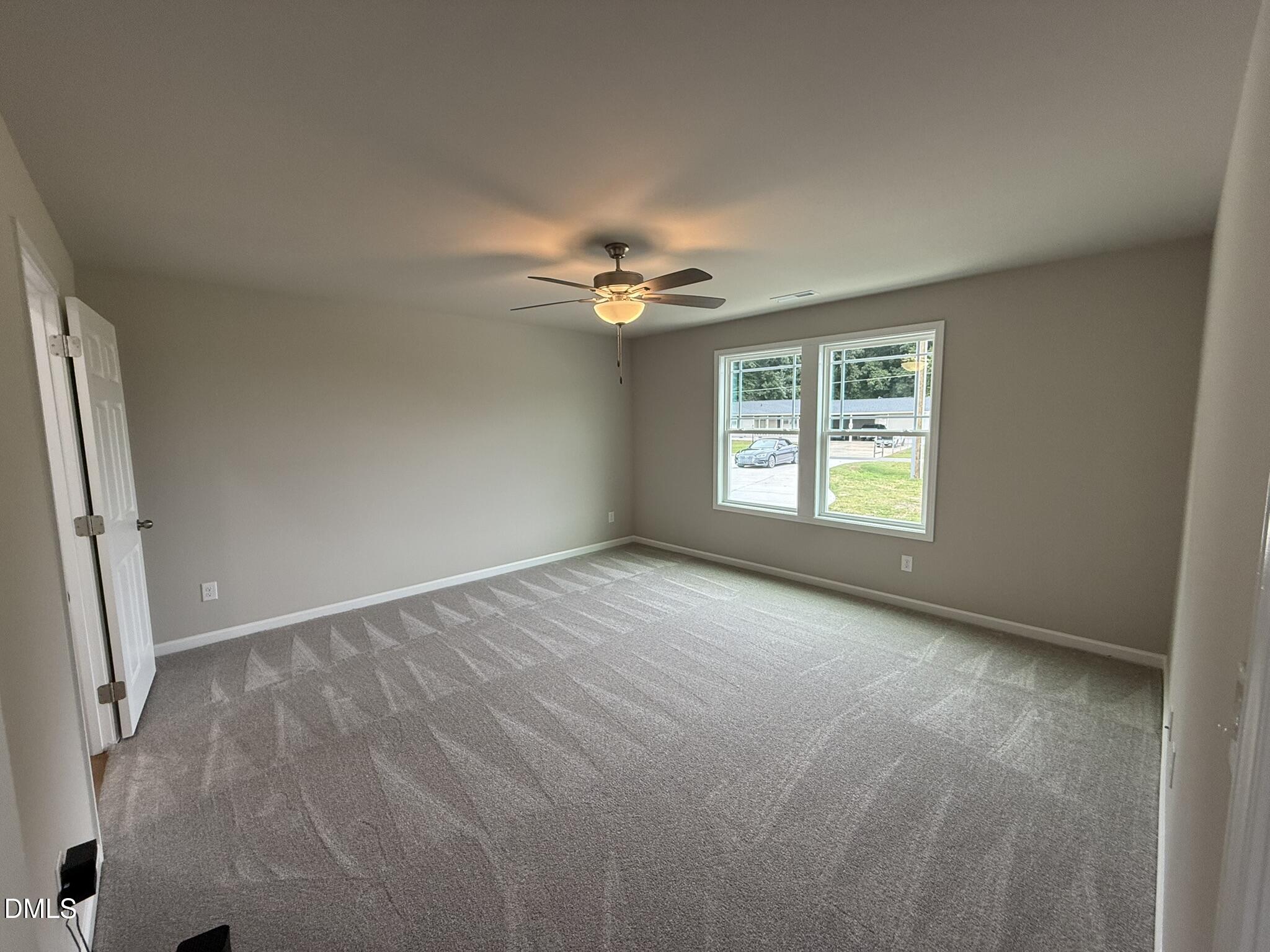 1853 Old Kenly Road Kenly, NC 27542 - Photo 12 of 22 an empty room with windows and chandelier fan
