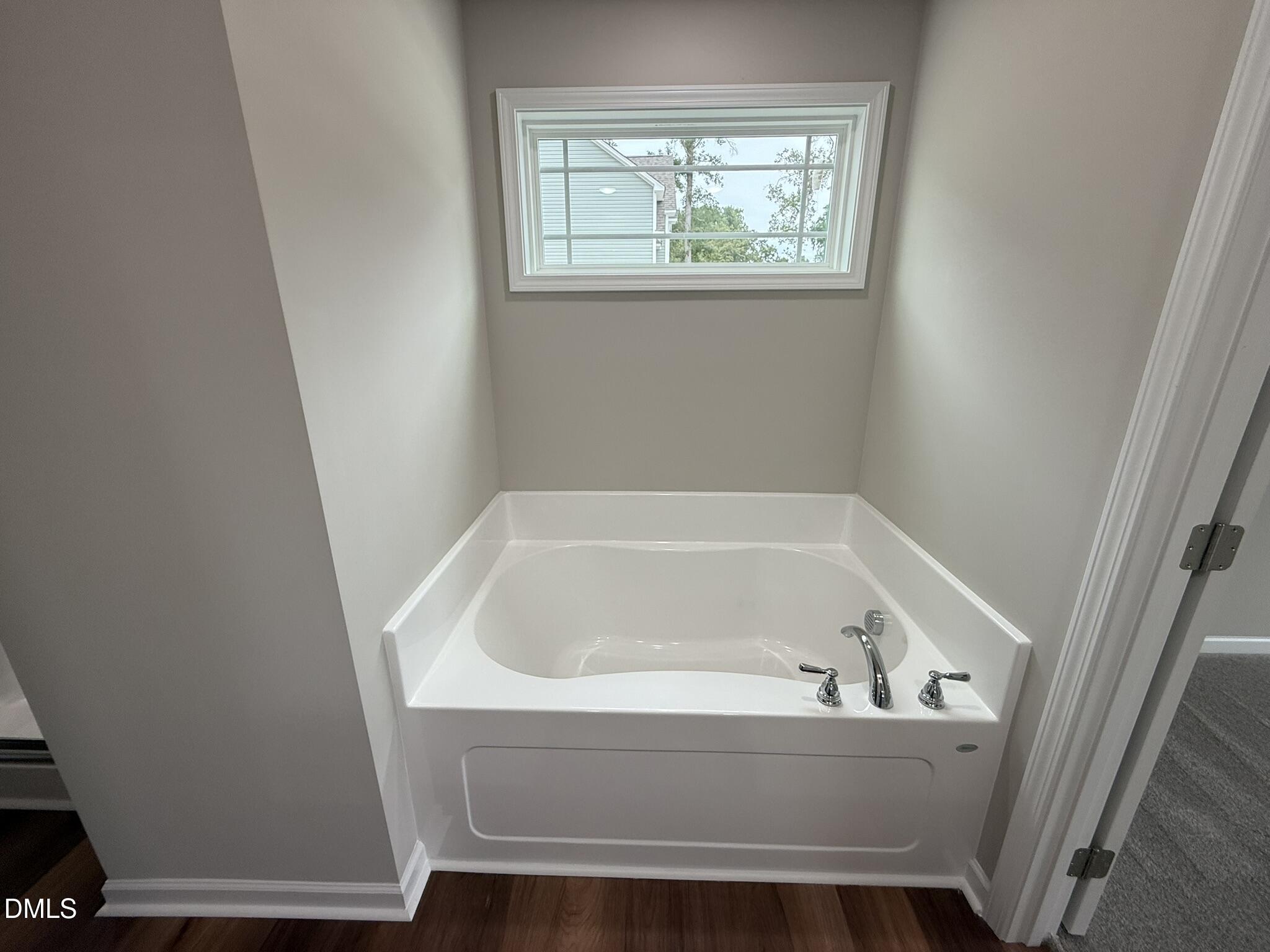 1853 Old Kenly Road Kenly, NC 27542 - Photo 16 of 22 a bathroom with bathtub and window