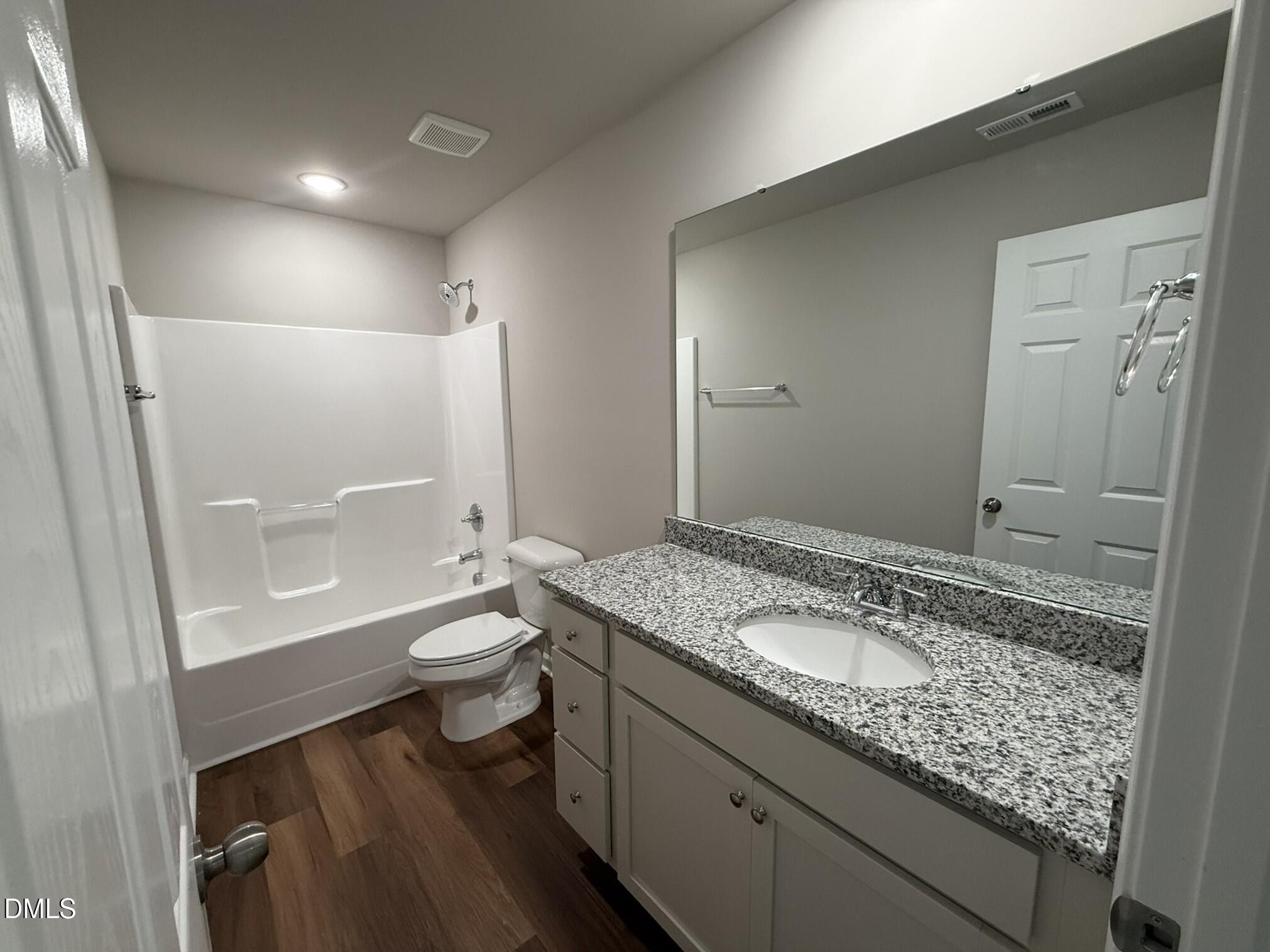 1853 Old Kenly Road Kenly, NC 27542 - Photo 20 of 22 a bathroom with a granite countertop sink toilet and shower