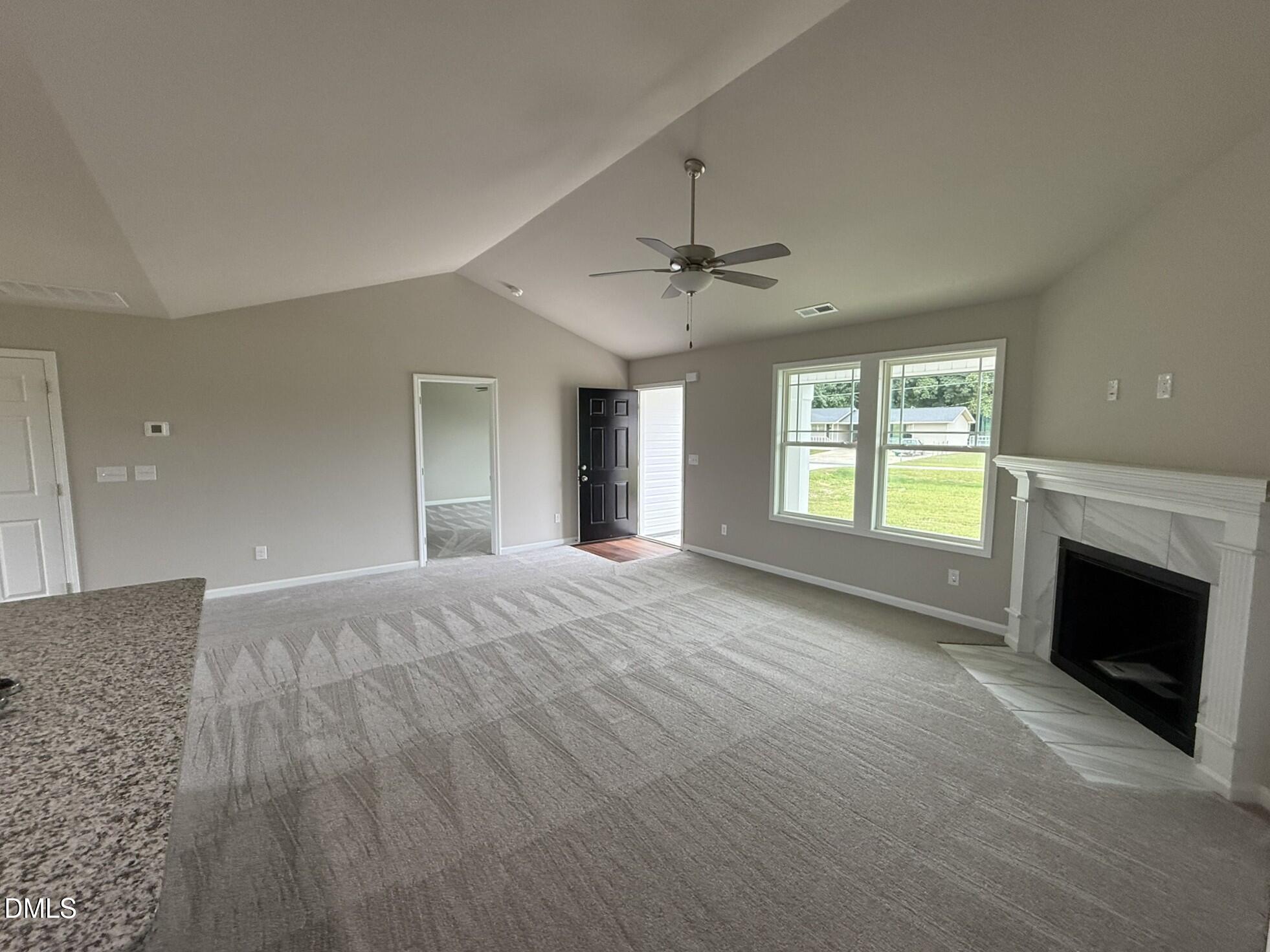 1853 Old Kenly Road Kenly, NC 27542 - Photo 5 of 22 a view of an empty room with window and fire place