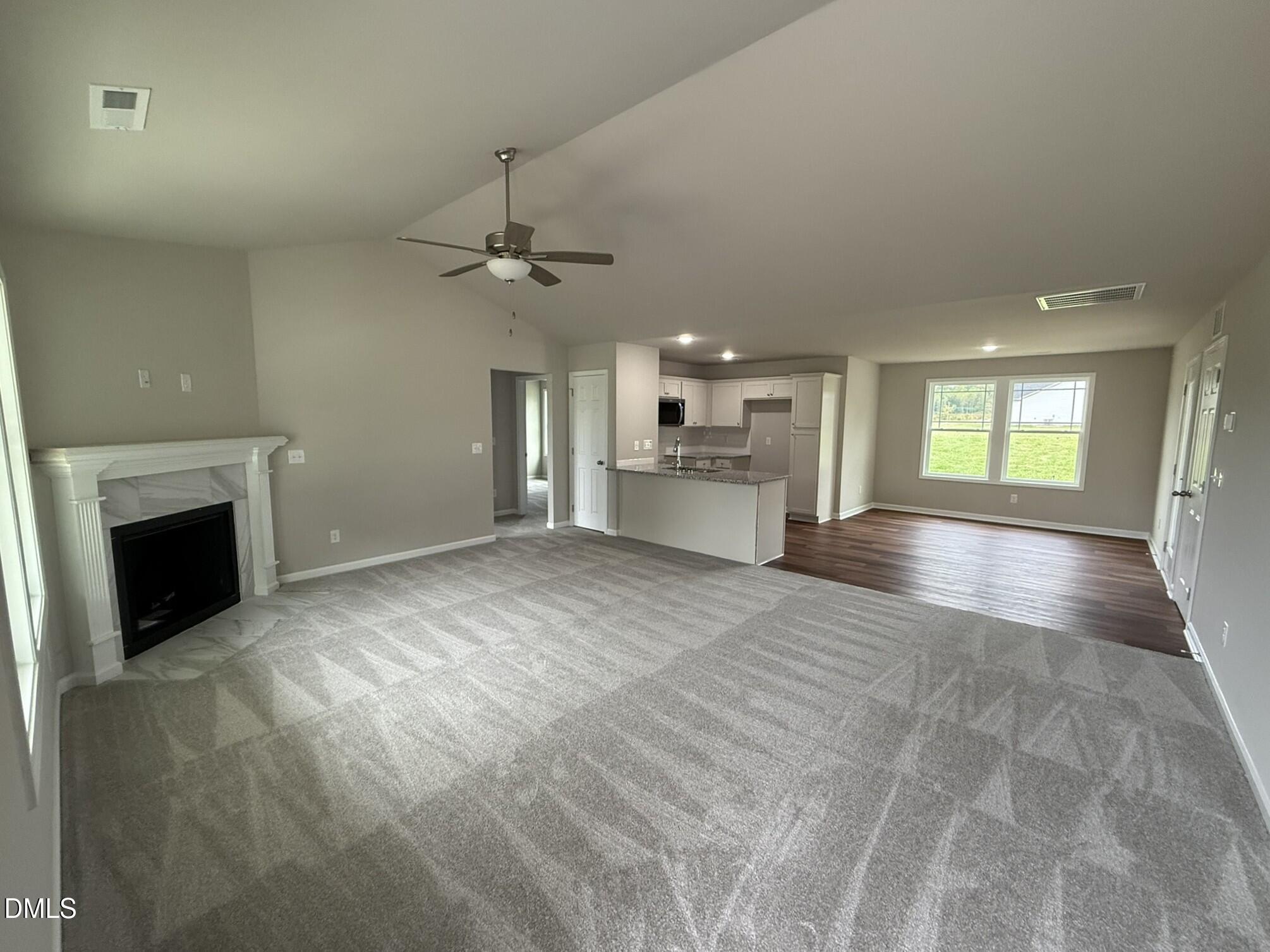 1853 Old Kenly Road Kenly, NC 27542 - Photo 7 of 22 a view of an empty room with a fireplace and chandelier fan