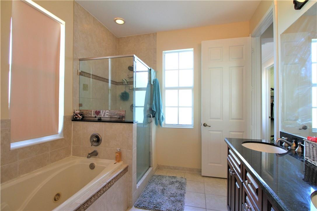 8316 Northwest 8th Terrace Boca Raton, FL 33487 - Photo 20 of 34 a bathroom with a tub sink and mirror
